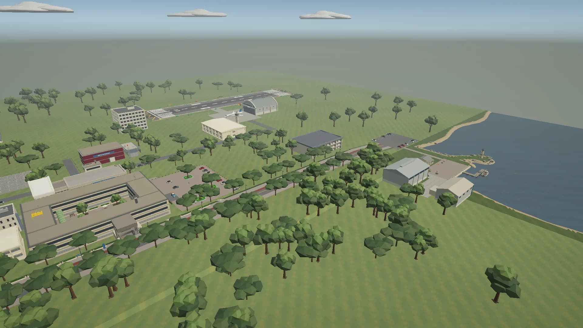 Aerial view of campus, with buildings among trees, an airstrip and the Oceanographic Center on the coast to the right.