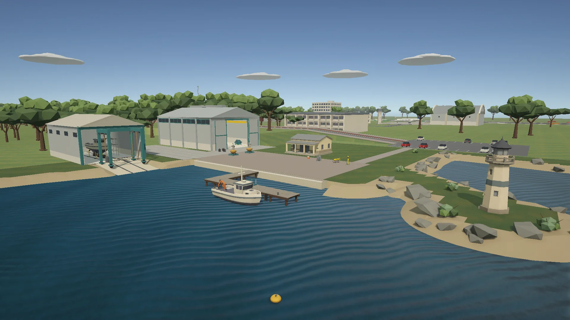 The campus coast seen from the sea, with a moored boat, pier, research sheds, boatyard and lighthouse.